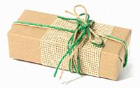 The box is packed in brown craft paper and tied with a rope on a white background, a gift.