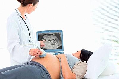 Pregnant woman undergoing ultrasound-stock-photo