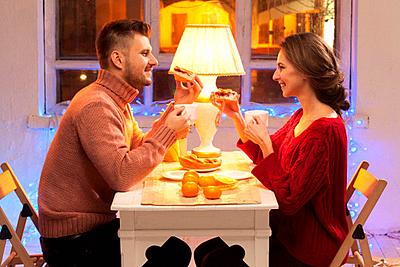 Portrait of romantic couple at Valentine&#39;s Day dinner with candles-stock-photo