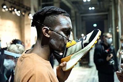 23 January 2021, Berlin: A model wears a sneaker as a mouth guard during the About You Fashion Week at Kraftwerk. This time the Berlin Fashion Week takes place on the internet, the shows are shown online because of the pandemic. Photo: Jörg Carstensen/dpa. - Berlin/Berlin/Germany-stock-photo