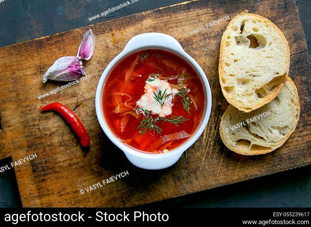 Borscht on a dark background top view. Russian or Ukrainian traditional soup. Flat lay, close-up