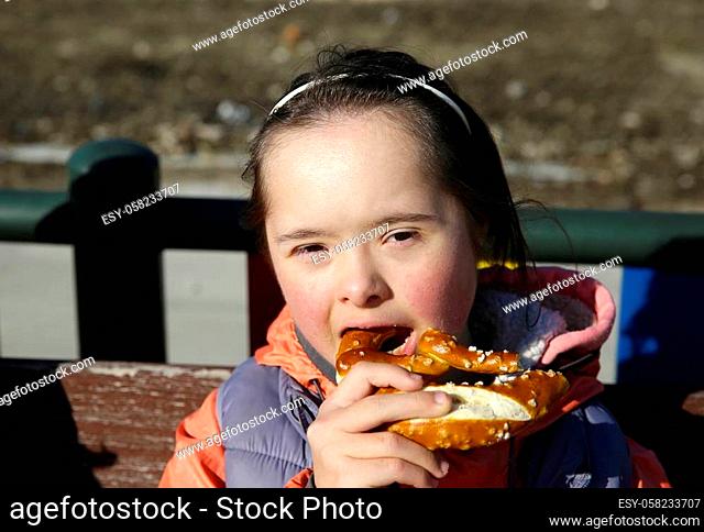 Portrait of little girl eating pretzel