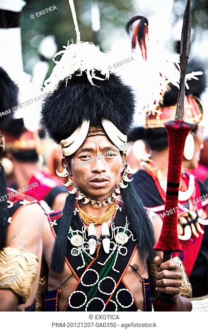 Naga tribesman in traditional outfit during the annual Hornbill Festival at Kisama, Kohima, Nagaland, India