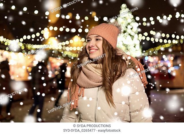 happy young woman at christmas market in winter