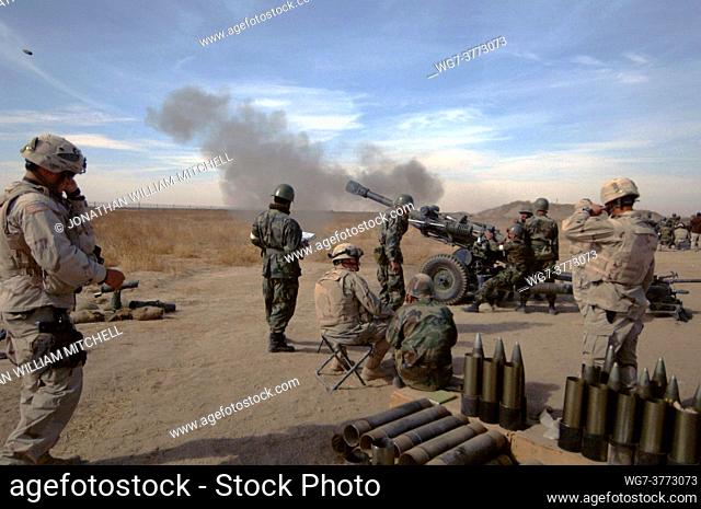 AFGHANISTAN Mangritae -- 17 Nov 2005 -- An artillery shell hurtles from an M-119 Howitzer during a joint training exercise at Kandahar Airfield, Afghanistan