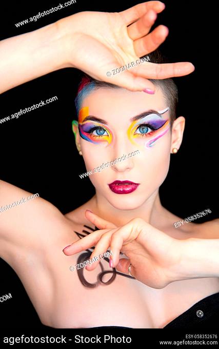 Young beautiful brunette with creative make up and body painting