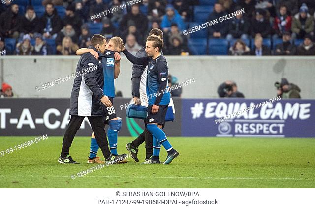 Hoffenheim's Felix Passlack (r) comforts his team colleague Philipp Ochs (l) who leaves the field after getting injured during the Europa League group C soccer...