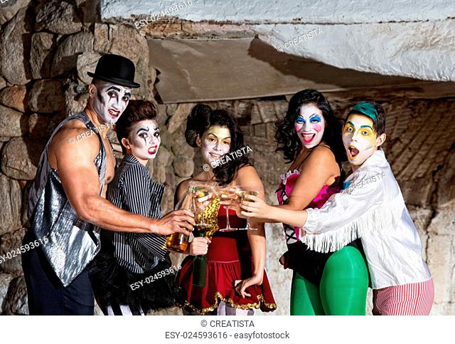 Martini drinking cirque clown ensemble toasting on stage