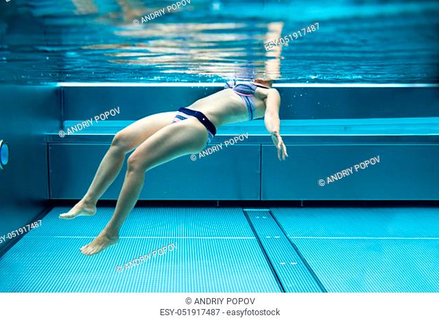 Below Water Photo Of Woman Swimming In Pool In