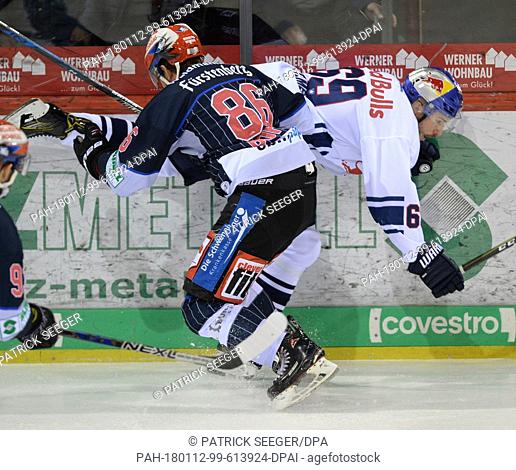 Schwenningen's Dominik Bohac (L) and Munich's Florian Kettemer (R) vie for the puck during the German Ice Hockey League (DEL) match between Schwenninger Wild...