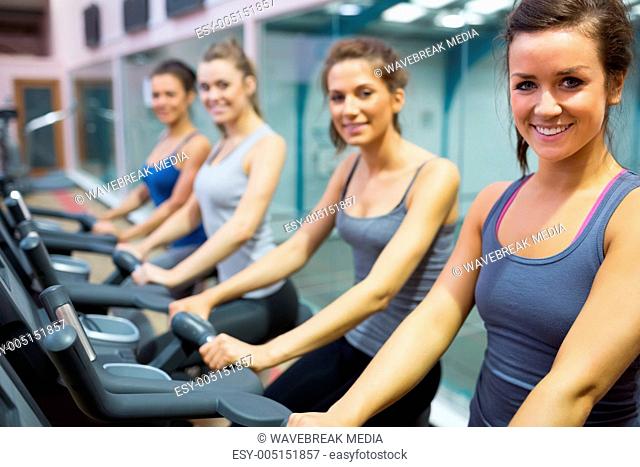 Smiling women at spinning class