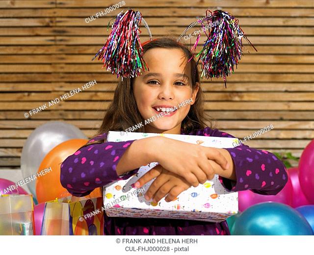 Girl 8-10 holding birthday present