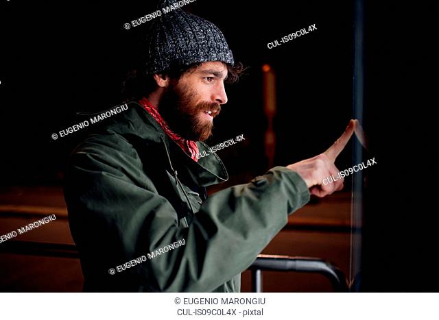 Bearded young man loitering on street