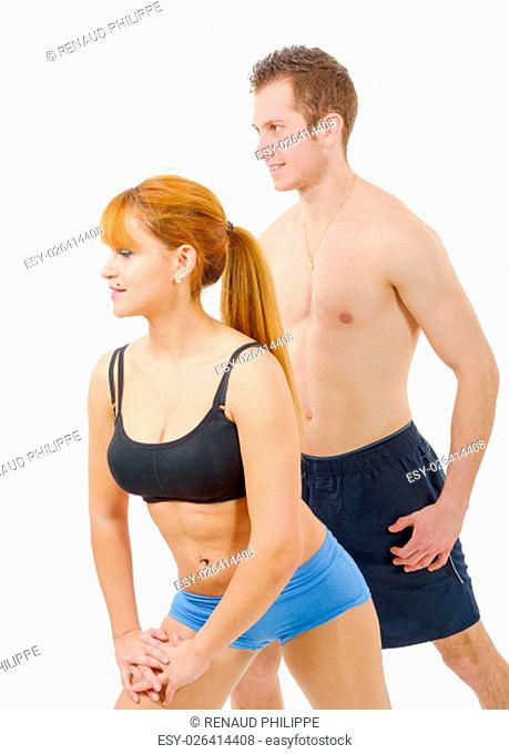 Beautiful young woman and man doing stretching exercises isolated on white background