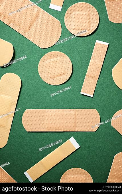 Close-up of some plasters on a green table