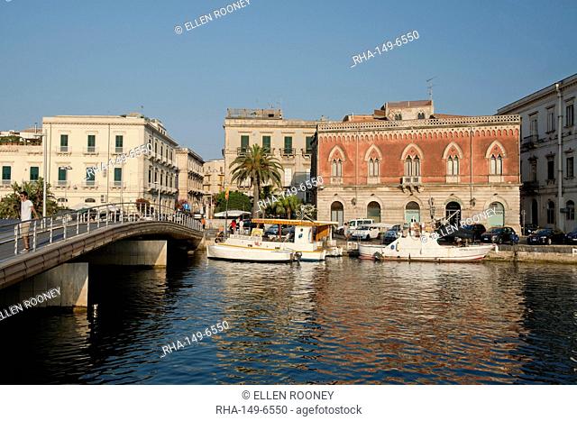 A deep red Venetian style building in the harbour in Ortigia, Syracuse, Sicily, Italy, Mediterranean, Europe