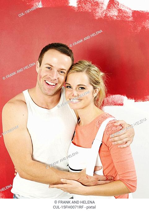 Couple in front of newly painted wall