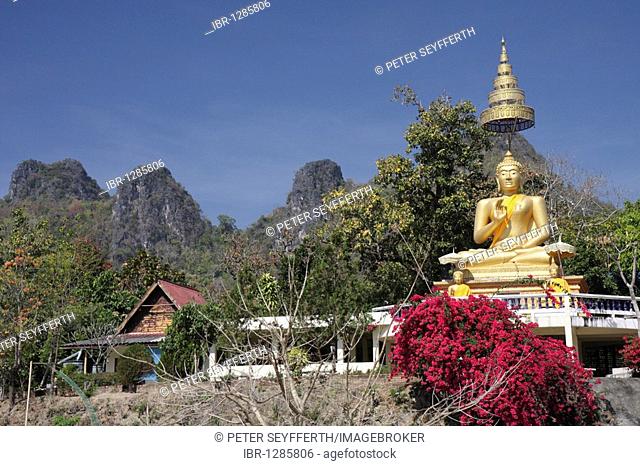 Golden statue of Buddha in front of mountains, Si Lanna National Park, Northern Thailand, Thailand, Asia