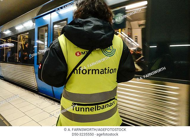 Stockholm, Sweden An information officer directs traffic at the Slussen Metro or Tunnelbana station at rush hour