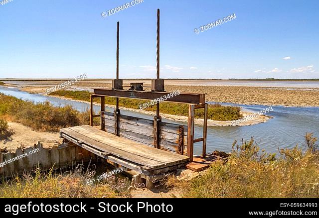 sunny scenery showing a sluice in a natural region named Camargue in southern France