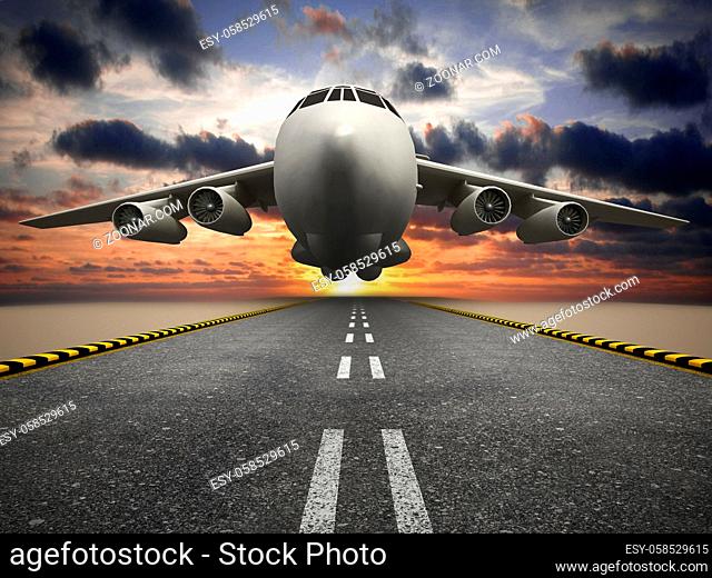 White passenger or cargo airplane taking off at sunset