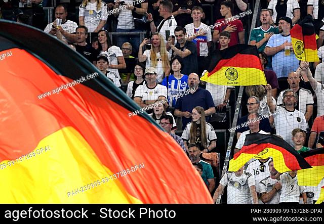 09 September 2023, Lower Saxony, Wolfsburg: Soccer: International Matches, Germany - Japan, Volkswagen Arena, Germany fans sing the national anthem before the...