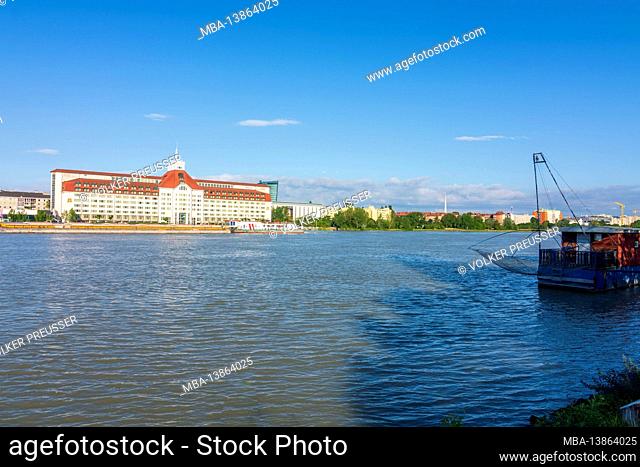 Vienna, river Donau (Danube), Hilton hotel, cargo ship, Daubel fishing boat in 02. Leopoldstadt, Wien, Austria