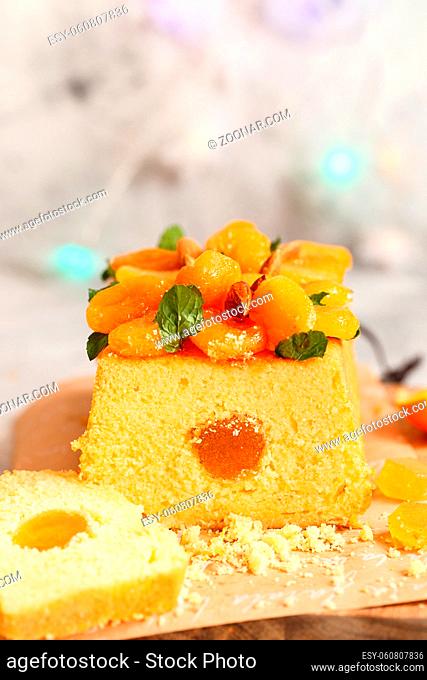 Orange Pound Cake flavored with freshly squeezed orange juice and zest decorated with dried apricots, mint leaves and almonds