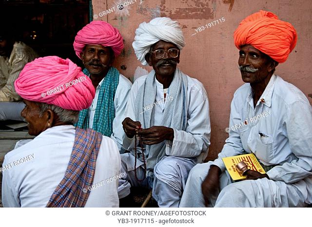 A group of men sit chatting on the street, Pushkar, Rajasthan, India