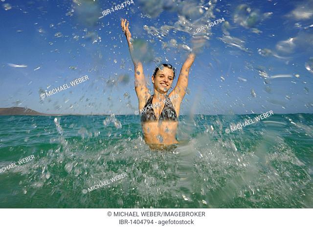 Young woman in the sea, symbolic image for vitality, lust for life, Playa Bajo Negro beach, Corralejo, Fuerteventura, Canary Islands, Spain, Europe