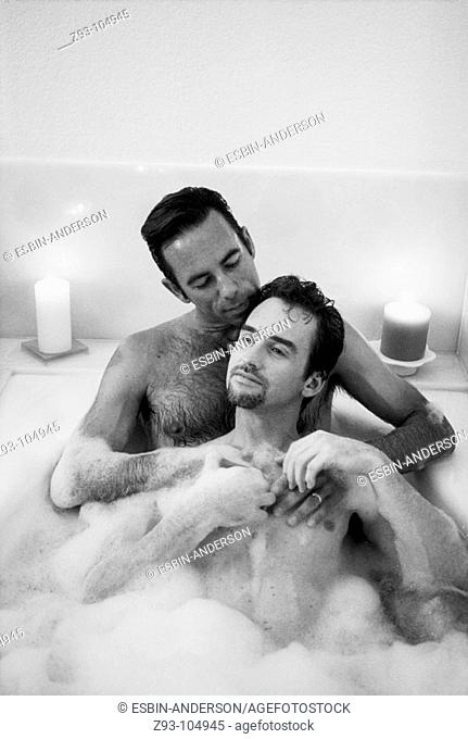 Gay couple sharing a bubble bath