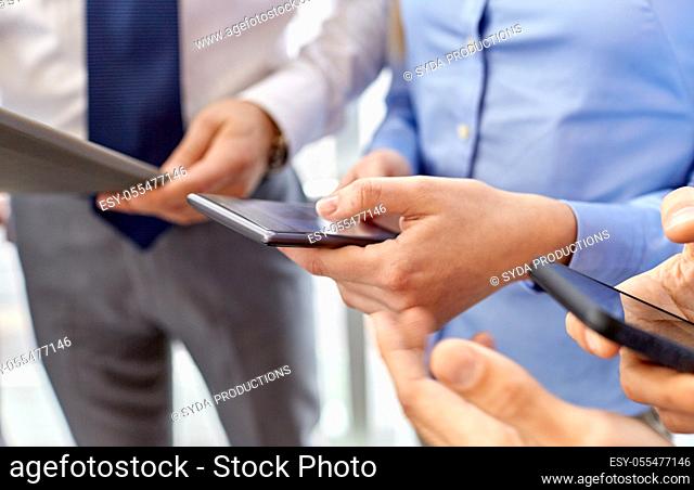 close up of hands with smartphone at office