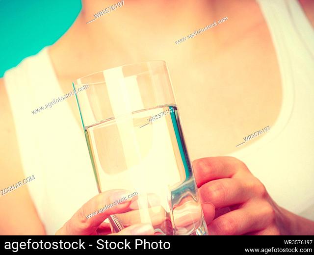 Hydration, healthy diet, drinking concept. Woman holding a glass of clean water