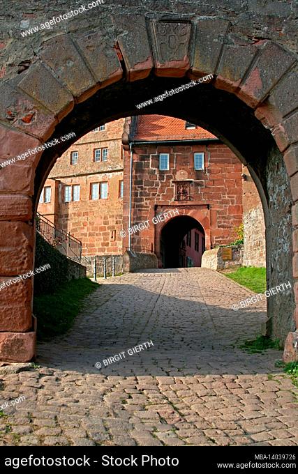 view through the outer gate to the gate building with wertheim coat of arms, breuberg castle, odenwald, hesse, germany