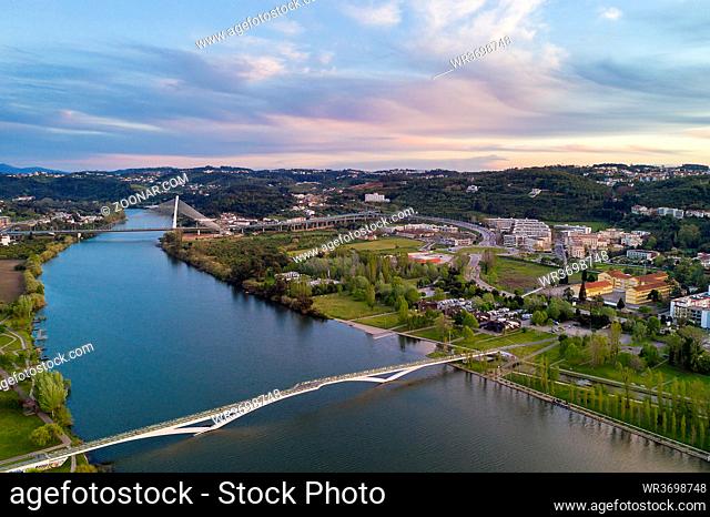 Coimbra drone aerial view of the city park, buildings and bridges at sunset, in Portugal