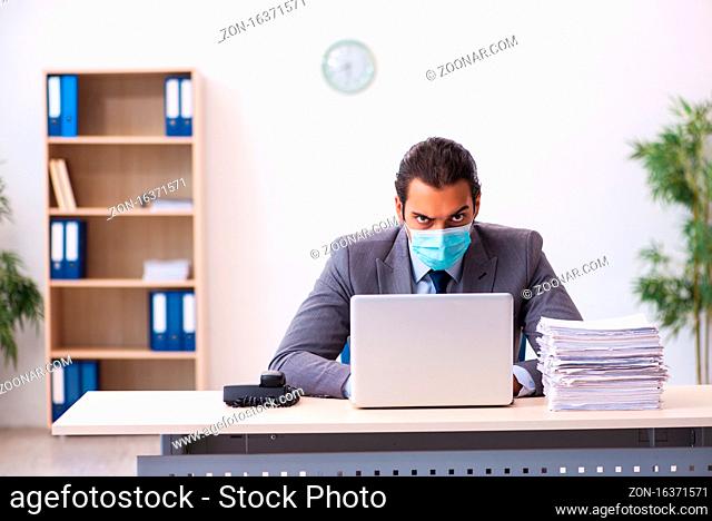 Young employee wearing mask during pandemic
