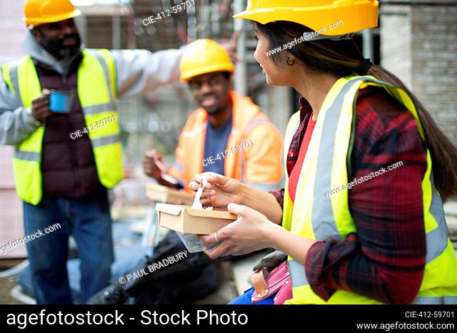 Construction workers eating lunch at construction site