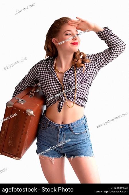 Retro pin-up girl with an old suitcase