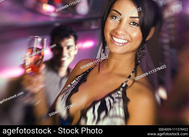 Portrait of Hispanic woman holding cocktail