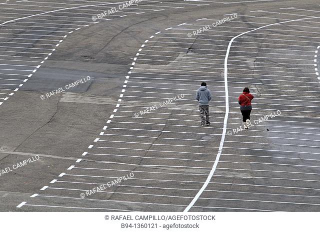 Couple walking in empty parking, La Molina ski resort, Girona province, Catalonia, Spain
