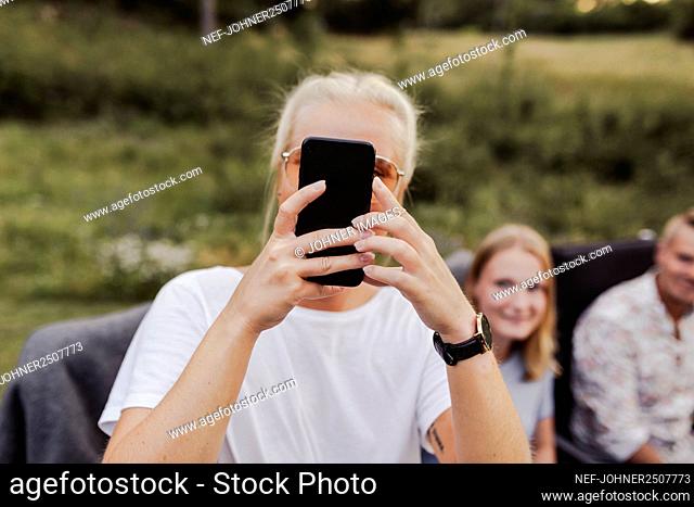 Woman photographing during garden party