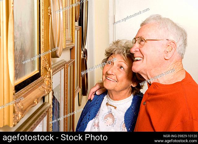Senior couple looking at photographs