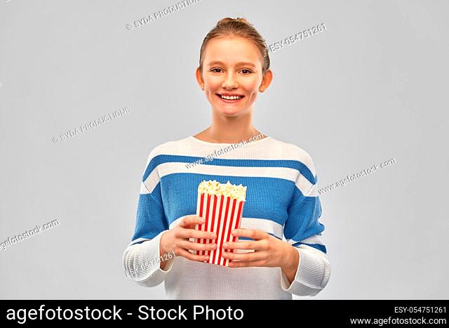 smiling teenage girl with popcorn