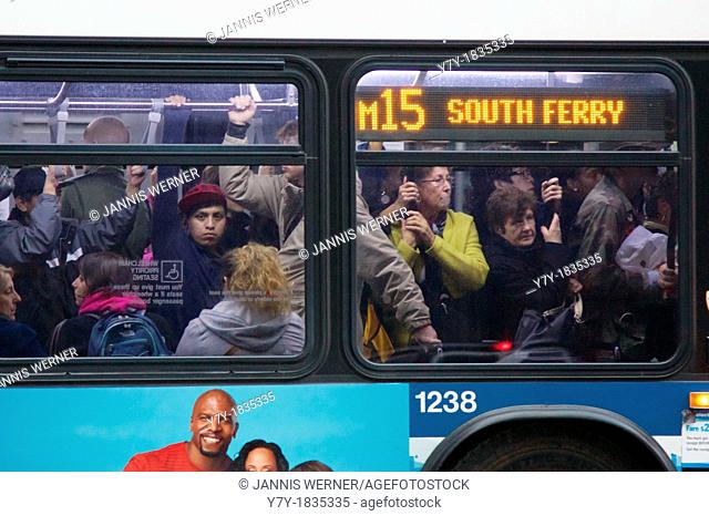 NEW YORK, NY, USA - OCTOBER 31, 2012: Bus Service having resumed after Hurricane Sandy hit the city, MTA busses remain rare and overcrowded in blacked-out Lower...