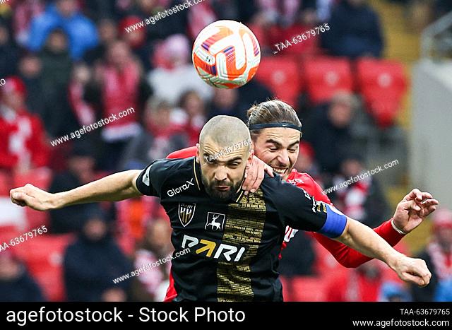 RUSSIA, MOSCOW - OCTOBER 22, 2023: Pari Nizhny Novgorod's Kirill Gotsuk (front) and Spartak Moscow's Srdan Babic jump to head the ball in a 2023/2024 Russian...