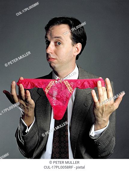 man holding womens knickers