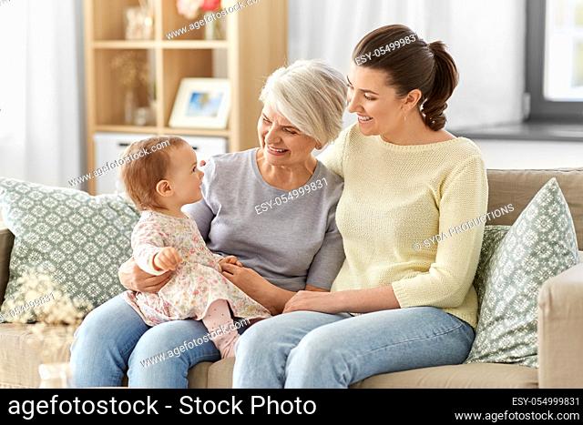 mother, daughter and grandmother on sofa at home