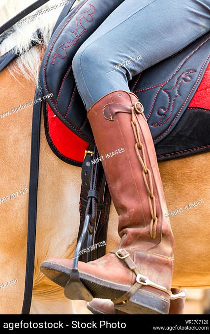 Horse rider with ornate leather riding boots, Tuscany Italy