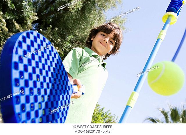 Boy Playing with Paddle and Tethered Ball