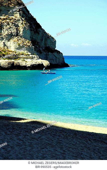 Beach with clear blue water below the steep cliffs, Tropea, Vibo Valentia, Calabria, Tyrrhenian Sea, South Italy, Italy, Europe